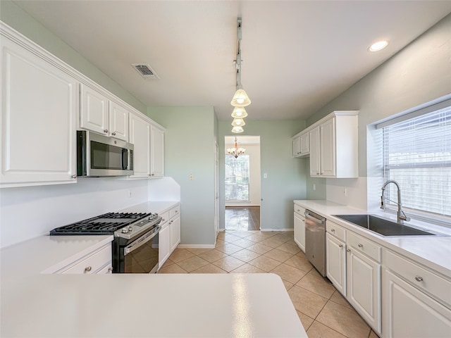 kitchen with white cabinets, a healthy amount of sunlight, sink, and appliances with stainless steel finishes