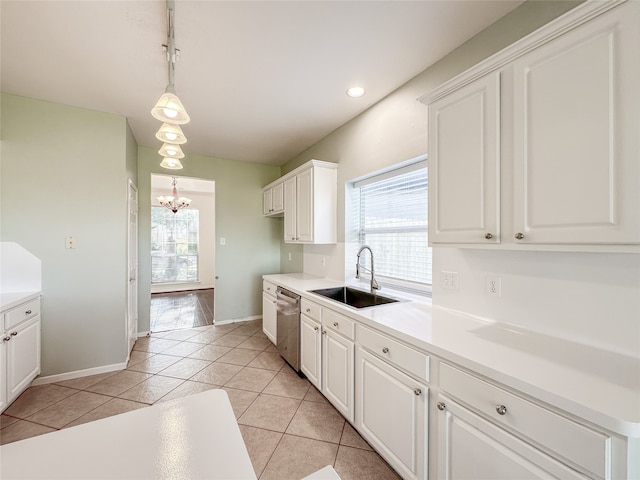 kitchen featuring white cabinets, a healthy amount of sunlight, sink, and hanging light fixtures