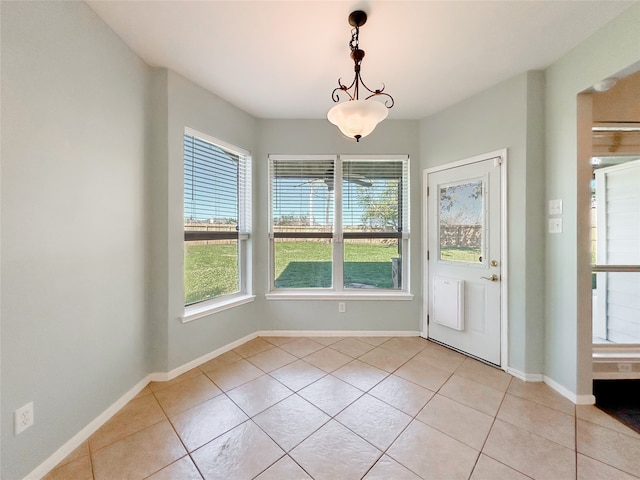 unfurnished dining area featuring light tile patterned floors