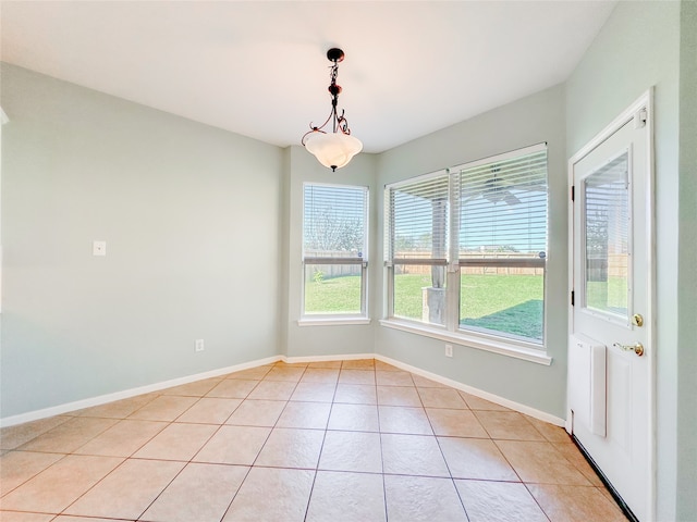 unfurnished dining area featuring light tile patterned floors