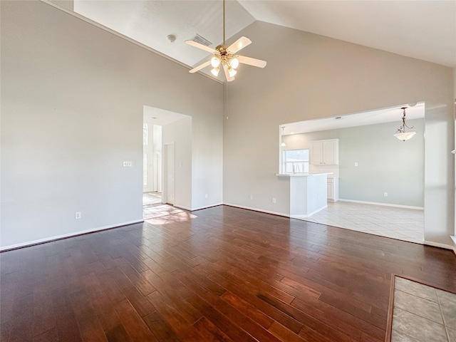 unfurnished living room featuring ceiling fan, high vaulted ceiling, and light hardwood / wood-style flooring