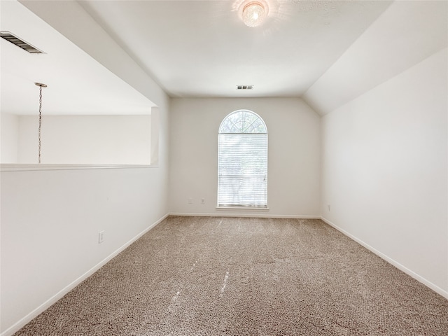 empty room with carpet and lofted ceiling