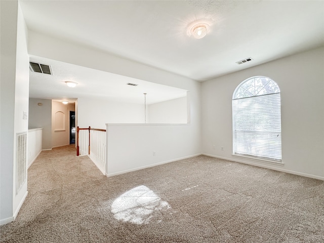 unfurnished room with light colored carpet