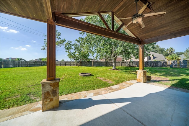 view of patio with ceiling fan and an outdoor fire pit