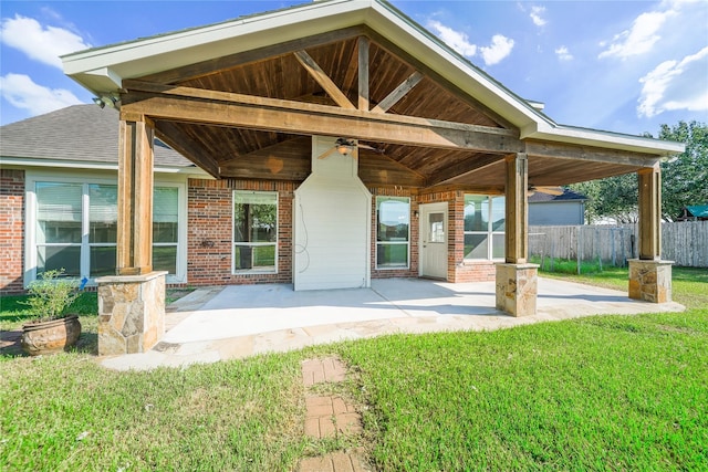 rear view of house featuring a patio area, ceiling fan, and a yard