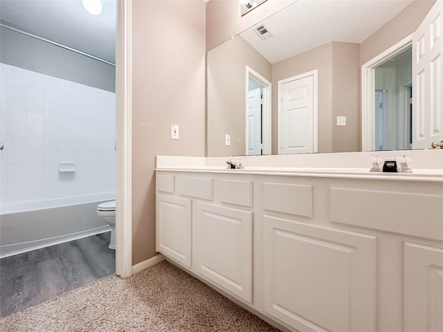 full bathroom featuring vanity, hardwood / wood-style flooring, toilet, and  shower combination