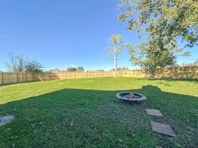 view of yard with an outdoor fire pit