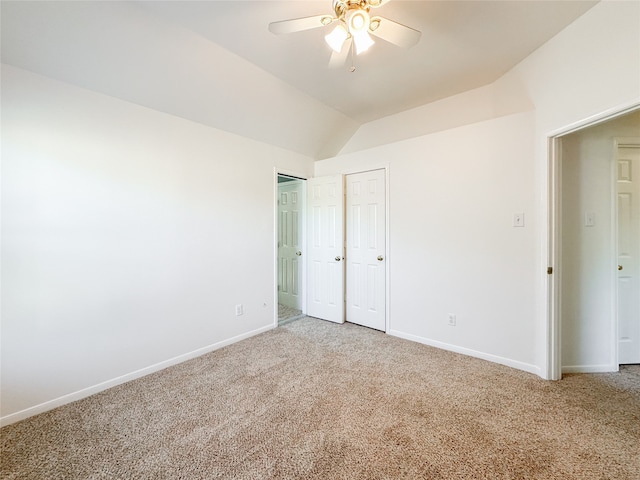 unfurnished bedroom featuring ceiling fan, carpet floors, and lofted ceiling