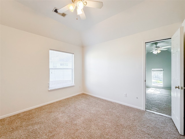 spare room with light colored carpet, ceiling fan, and lofted ceiling