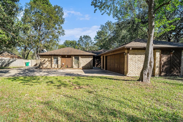 rear view of house with a yard and a garage