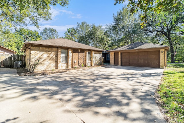 view of front of house with central AC unit and a garage