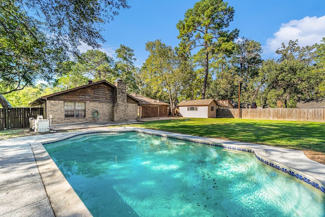 view of swimming pool featuring a shed and a lawn