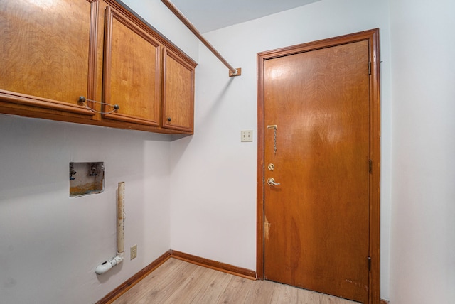 laundry room featuring light hardwood / wood-style flooring, cabinets, and washer hookup