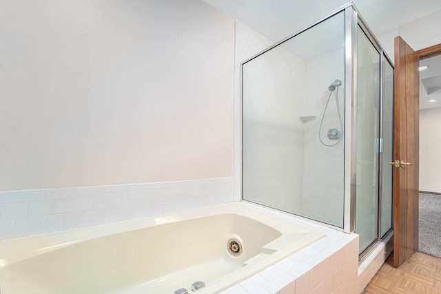 bathroom featuring separate shower and tub