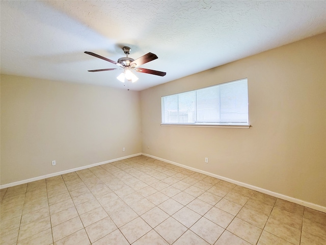 unfurnished room with light tile patterned floors, a textured ceiling, and ceiling fan