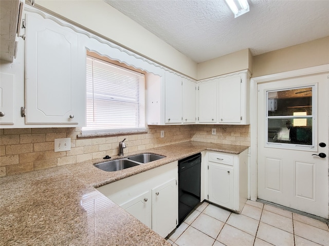 kitchen featuring white cabinetry, sink, black dishwasher, tasteful backsplash, and a textured ceiling