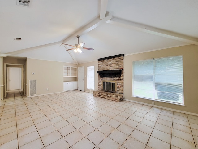 unfurnished living room featuring lofted ceiling with beams, ceiling fan, a wealth of natural light, and a brick fireplace