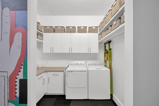 laundry area featuring washer and clothes dryer and cabinets