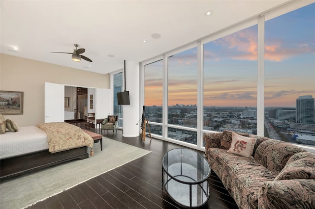 bedroom with ceiling fan, floor to ceiling windows, and dark hardwood / wood-style floors