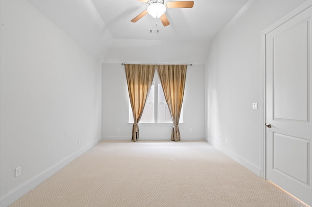 carpeted spare room with ceiling fan and lofted ceiling