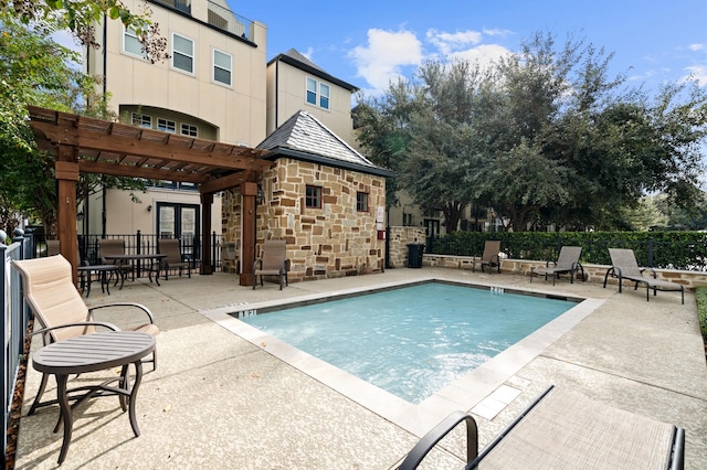 view of pool featuring a pergola, a patio, and french doors