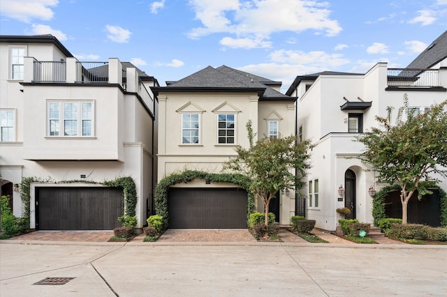 view of front of home with a balcony and a garage