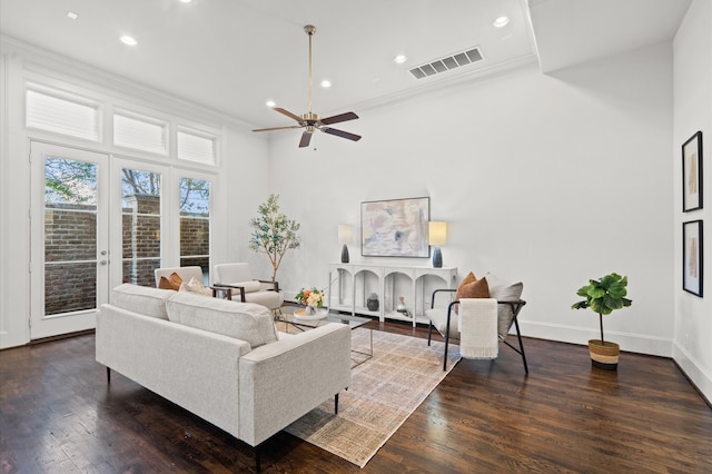 living room featuring crown molding, a towering ceiling, ceiling fan, and dark hardwood / wood-style floors