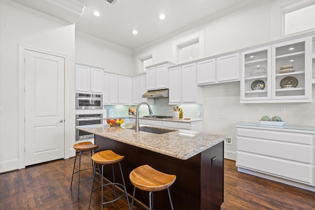 kitchen with white cabinetry, dark hardwood / wood-style flooring, and an island with sink