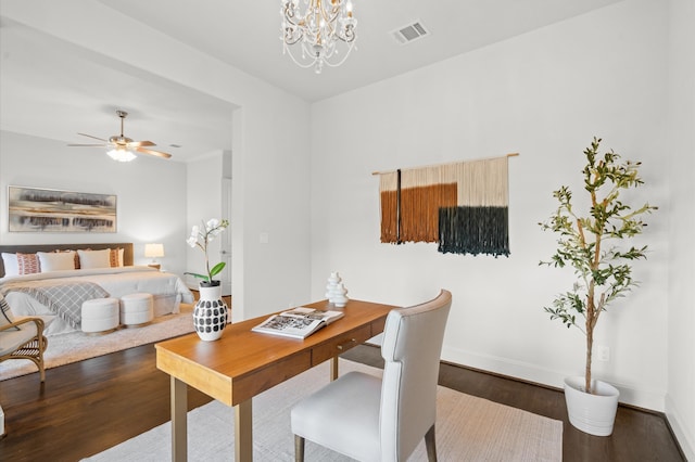 dining room with dark hardwood / wood-style floors and ceiling fan with notable chandelier