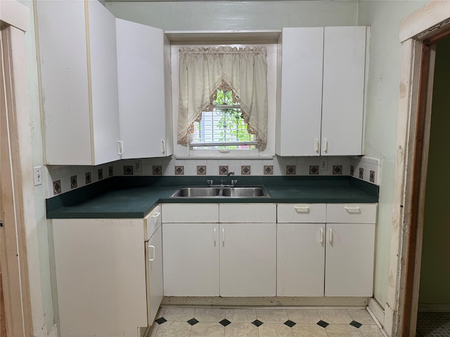 512 Threlkeld St, Houston, TX 77007 - kitchen with white cabinets, dark countertops, and a sink