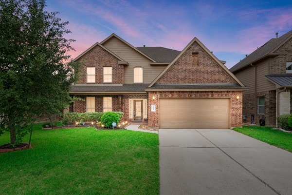 craftsman inspired home featuring a garage and a lawn