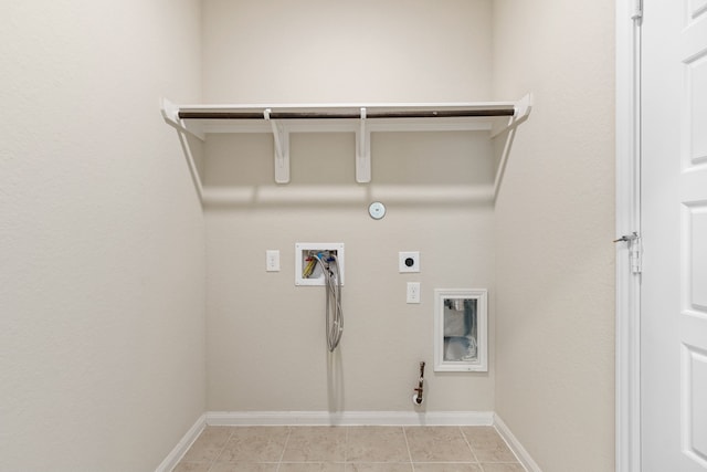 clothes washing area with electric dryer hookup, hookup for a gas dryer, light tile patterned floors, and hookup for a washing machine