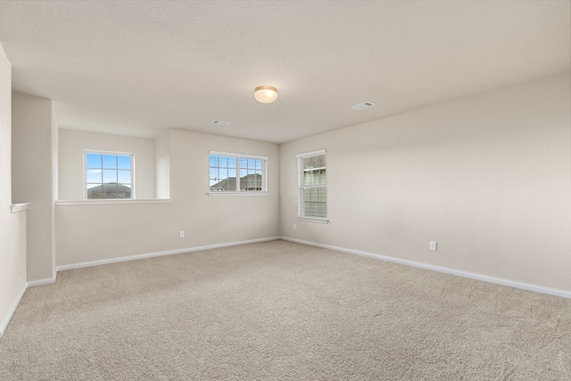 empty room featuring light colored carpet