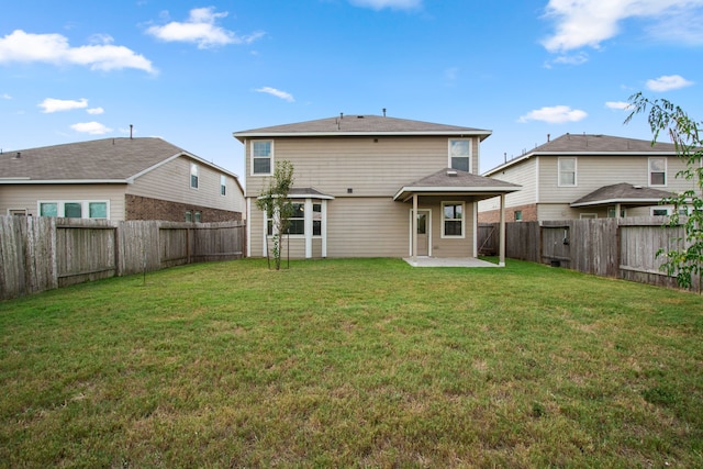 back of house featuring a yard and a patio