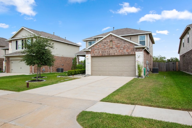 front of property featuring a front lawn, a garage, and central AC unit