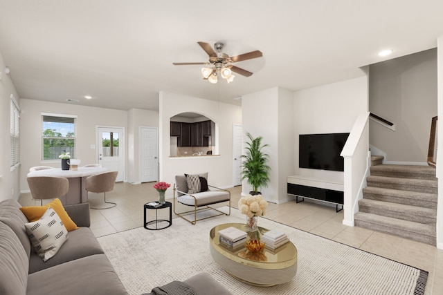 tiled living room with ceiling fan