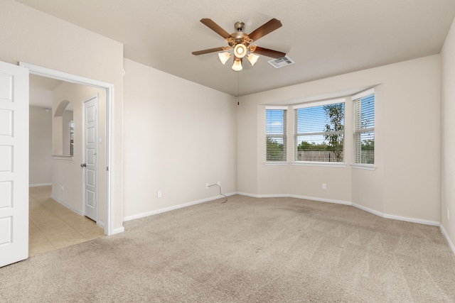 carpeted empty room with ceiling fan