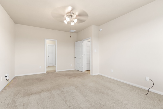 empty room with light colored carpet and ceiling fan