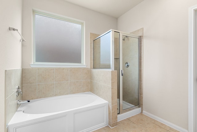 bathroom with tile patterned floors and shower with separate bathtub