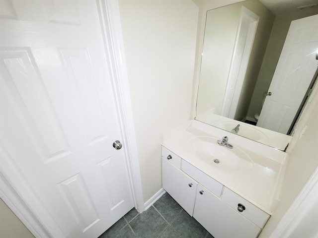 bathroom with tile patterned flooring, vanity, and toilet