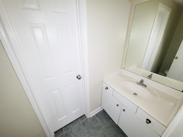 bathroom featuring tile patterned flooring, vanity, and toilet