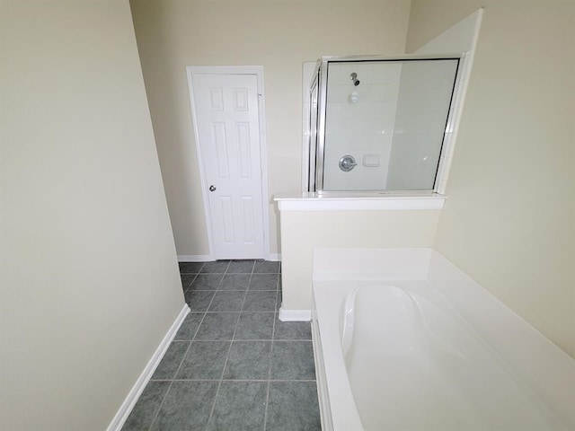 bathroom featuring tile patterned floors and independent shower and bath