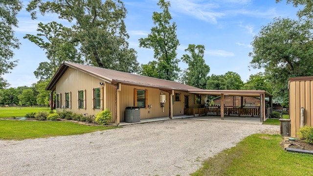 ranch-style house with central AC unit and a carport