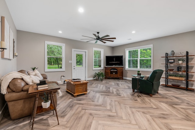 living room with plenty of natural light, ceiling fan, and light parquet floors