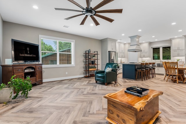 living room featuring ceiling fan and light parquet flooring