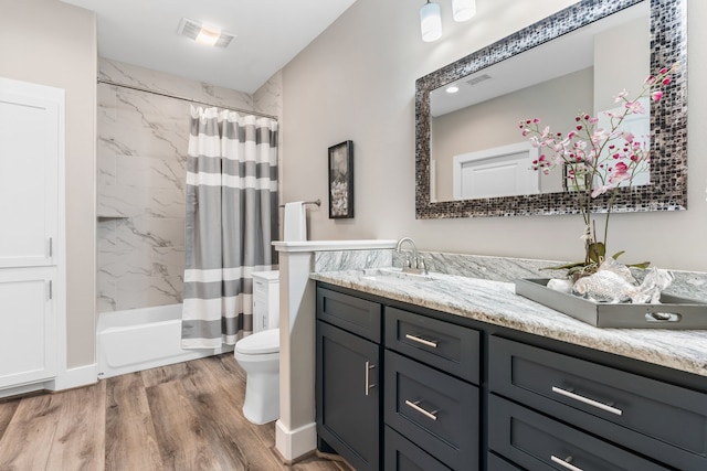 full bathroom with vanity, hardwood / wood-style flooring, toilet, and shower / bathtub combination with curtain