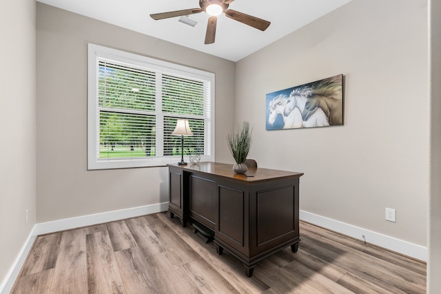 home office featuring ceiling fan and light hardwood / wood-style floors