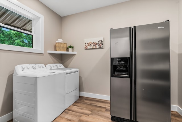 washroom featuring light wood-type flooring and washing machine and clothes dryer