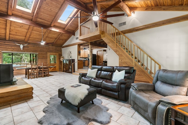 tiled living room featuring a skylight, ceiling fan, beam ceiling, high vaulted ceiling, and wooden ceiling