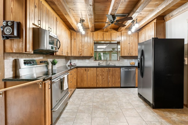 kitchen with sink, ceiling fan, tasteful backsplash, beamed ceiling, and stainless steel appliances